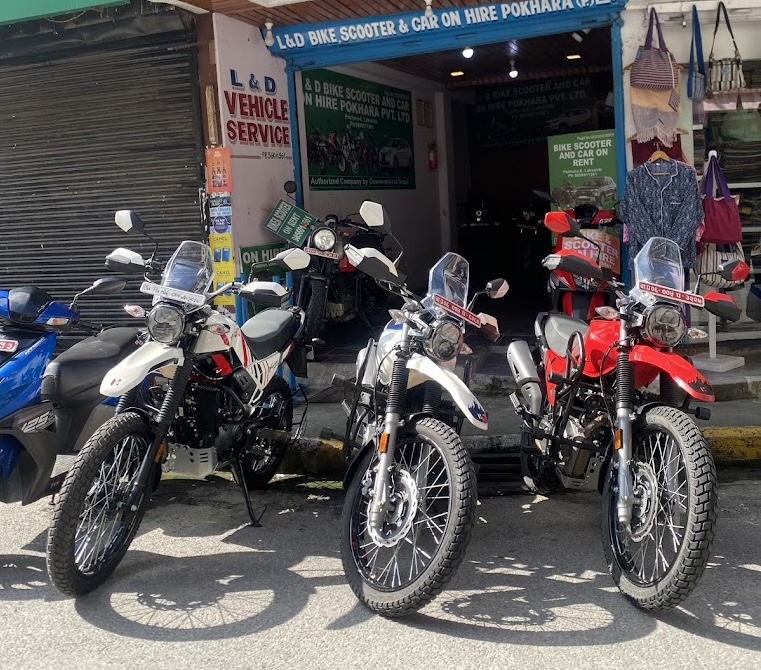 Modern storefront of Bike rental near me in Pokhara Hub with large glass windows and green signage